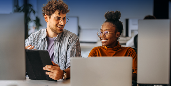 Two people working on computers